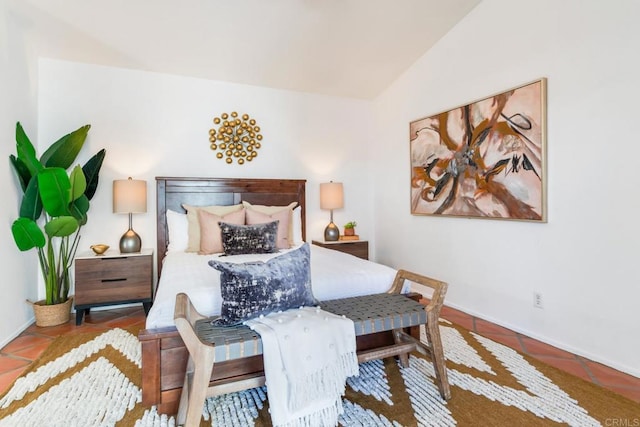 tiled bedroom featuring lofted ceiling