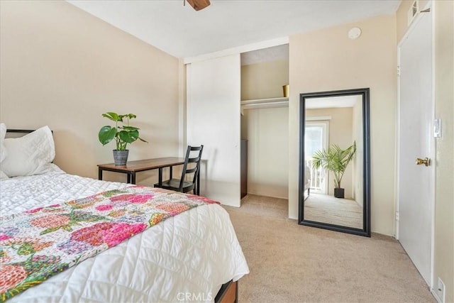 bedroom with light colored carpet and a closet