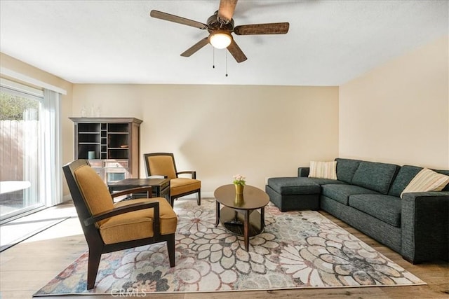 living room with ceiling fan and light wood-type flooring