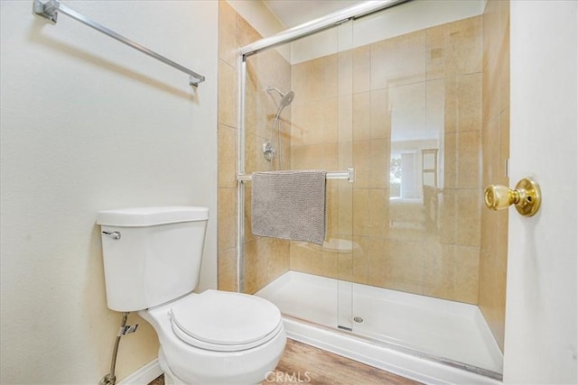 bathroom featuring walk in shower and toilet