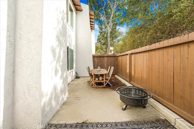 view of patio / terrace with a fire pit