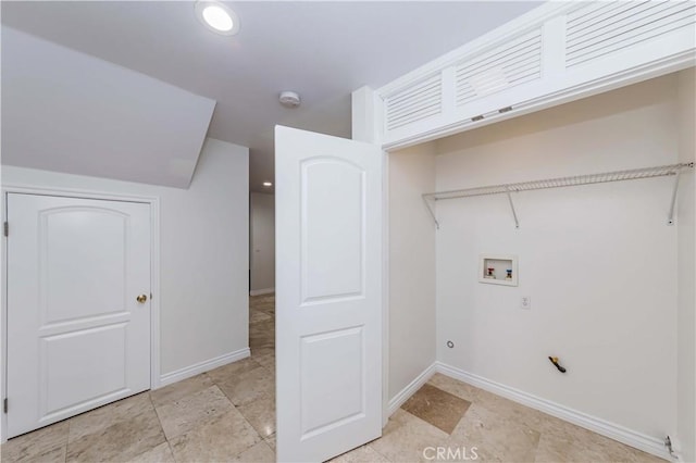 clothes washing area featuring hookup for a washing machine, laundry area, and baseboards