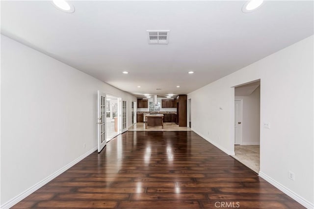 unfurnished living room with dark hardwood / wood-style floors