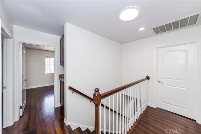 stairs featuring hardwood / wood-style floors