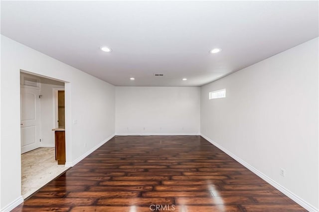 unfurnished room featuring dark hardwood / wood-style flooring