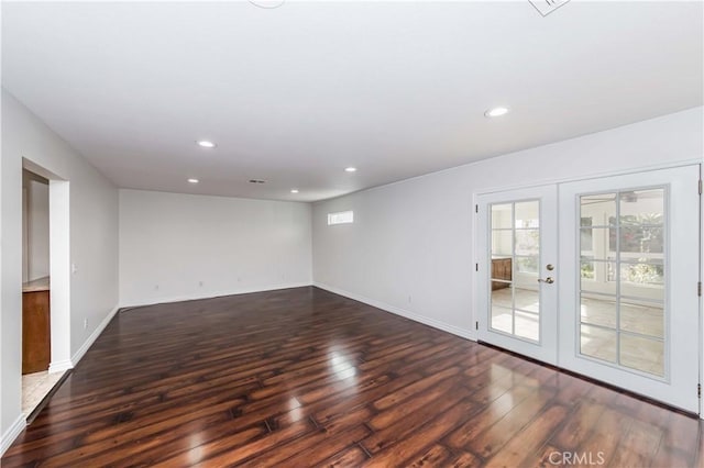 spare room with baseboards, french doors, hardwood / wood-style floors, and recessed lighting