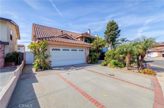 view of front of property featuring a tiled roof, driveway, and stucco siding