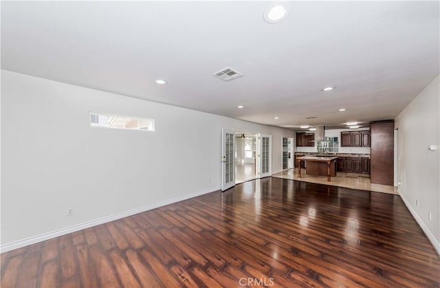 unfurnished living room featuring dark hardwood / wood-style flooring