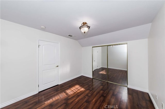 unfurnished bedroom with baseboards, visible vents, and wood finished floors