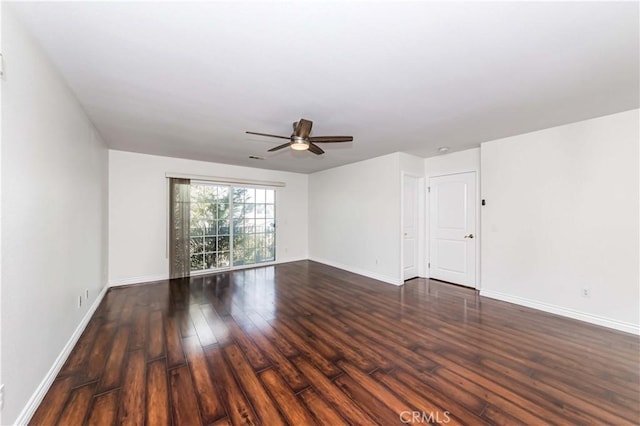 empty room featuring a ceiling fan, baseboards, and wood finished floors