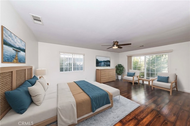 bedroom with ceiling fan, wood finished floors, and visible vents