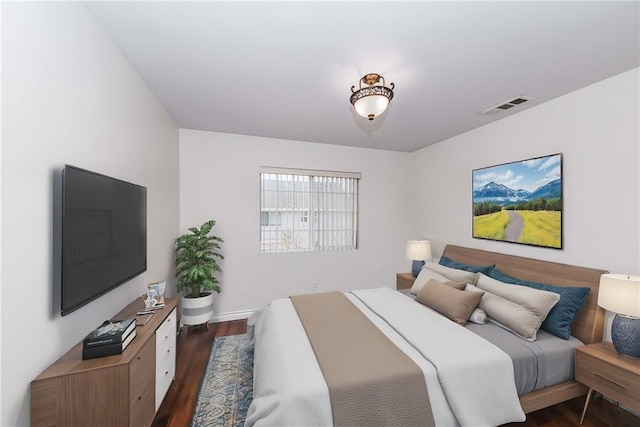 bedroom with dark wood-type flooring and visible vents