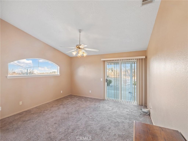 carpeted spare room with lofted ceiling and ceiling fan