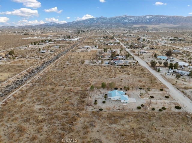 birds eye view of property featuring a mountain view