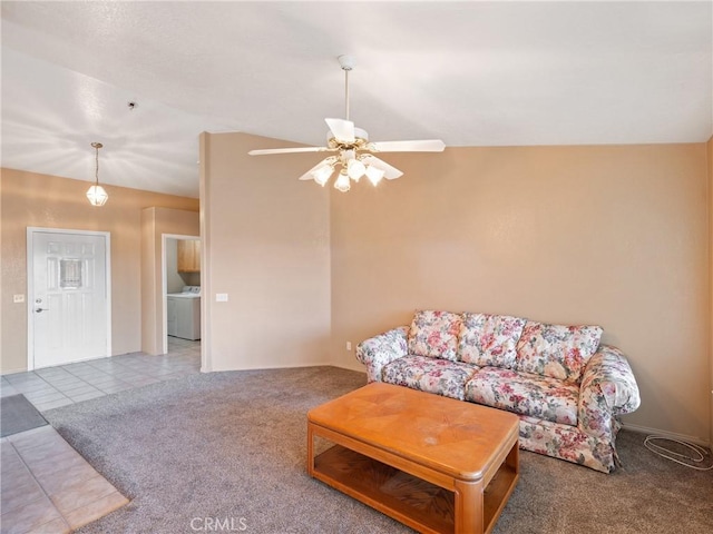 tiled living room featuring ceiling fan, lofted ceiling, and washer / dryer