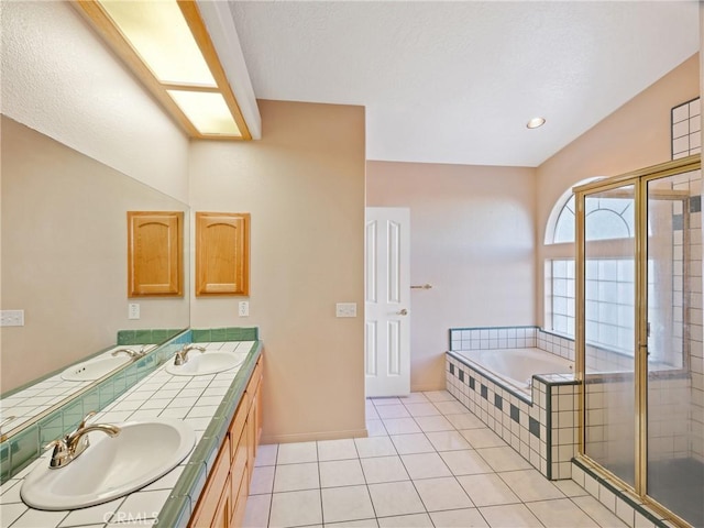 bathroom featuring tile patterned flooring, vanity, and shower with separate bathtub