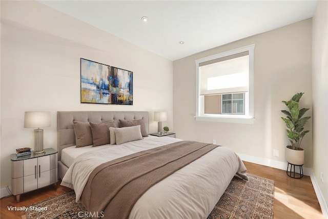 bedroom with hardwood / wood-style floors