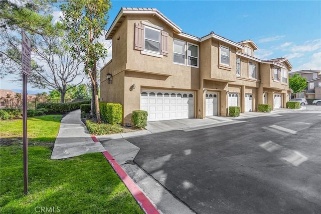 view of property with a garage and a front yard