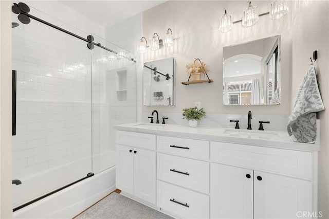 bathroom with vanity and shower / bath combination with glass door