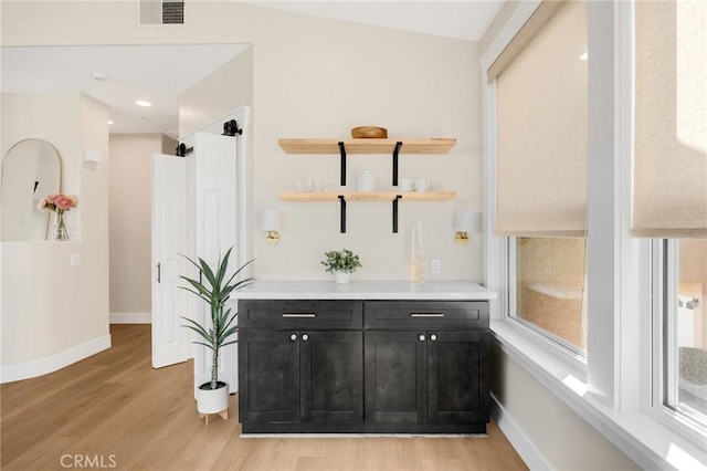 bar with light hardwood / wood-style flooring