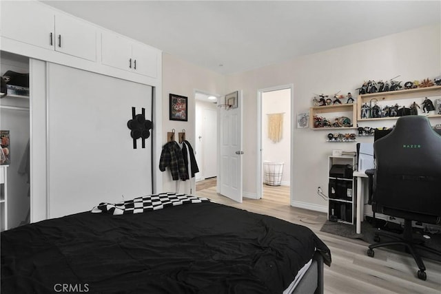 bedroom featuring a closet and light wood-type flooring