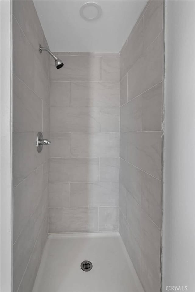 bathroom with tiled shower