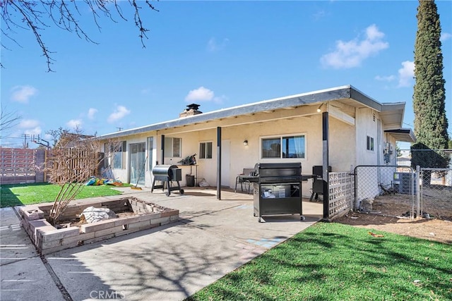 rear view of house with a yard and a patio area