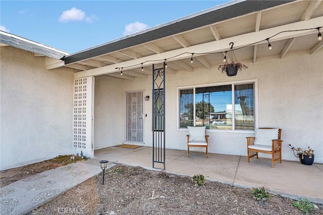 entrance to property featuring a patio area