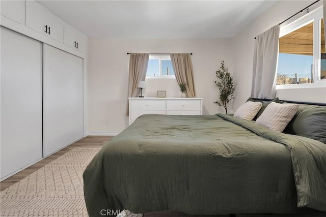 bedroom with a closet and light wood-type flooring