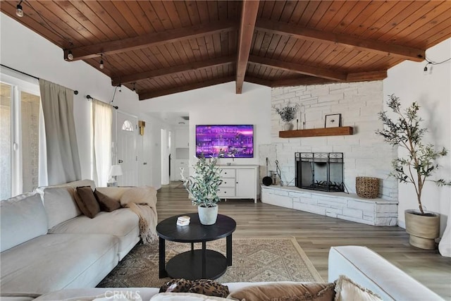 living room featuring wood-type flooring, vaulted ceiling with beams, wooden ceiling, and a fireplace