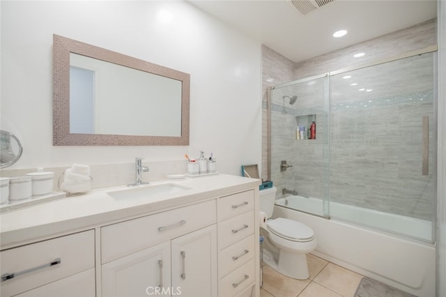 full bathroom featuring enclosed tub / shower combo, vanity, toilet, and tile patterned flooring