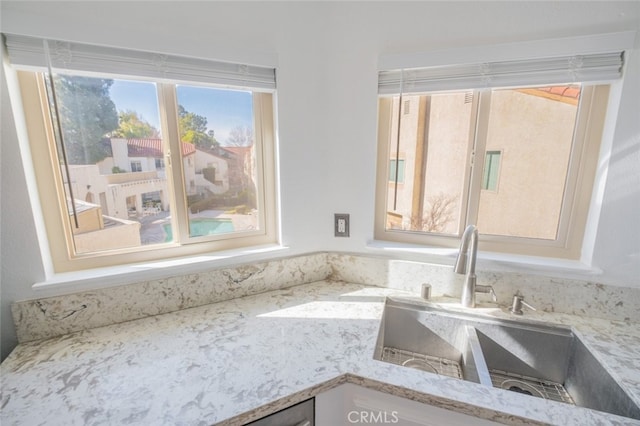 room details with light stone counters and sink