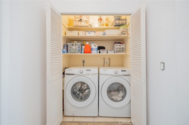 clothes washing area featuring washer and clothes dryer