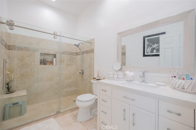 bathroom with vanity, walk in shower, tile patterned floors, and toilet