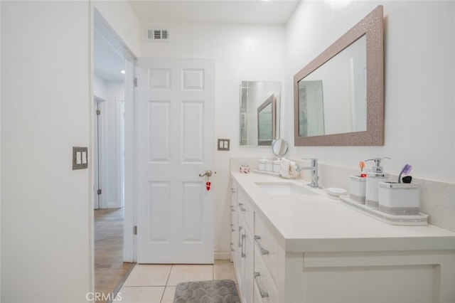 bathroom featuring tile patterned flooring and vanity