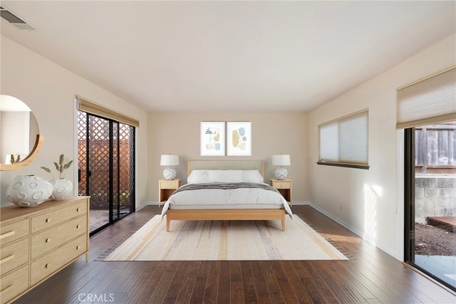 bedroom featuring dark wood-type flooring and access to outside