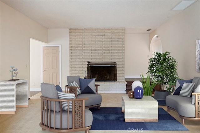 living room featuring carpet flooring and a fireplace