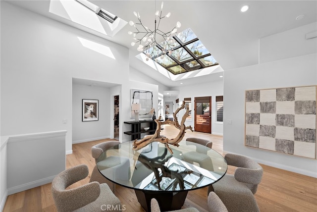 2335 Hillview Dr, Laguna Beach, CA 92651 - dining room with a skylight, high vaulted ceiling, a chandelier, light wood-type flooring, and recessed lighting