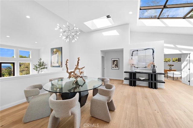 2335 Hillview Dr, Laguna Beach, CA 92651 - dining area with a skylight, high vaulted ceiling, a chandelier, wood-type flooring, and recessed lighting