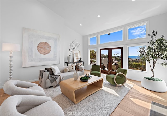 living area featuring baseboards, recessed lighting, french doors, wood finished floors, and high vaulted ceiling