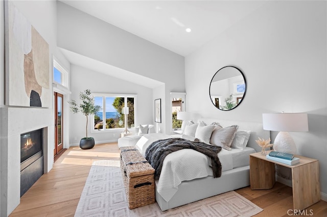 2335 Hillview Dr, Laguna Beach, CA 92651 - bedroom with high vaulted ceiling, light wood-style floors, a glass covered fireplace, and recessed lighting