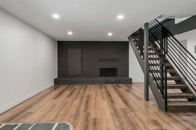 unfurnished living room featuring a fireplace and hardwood / wood-style floors