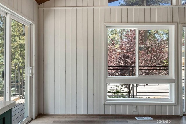 unfurnished sunroom featuring lofted ceiling