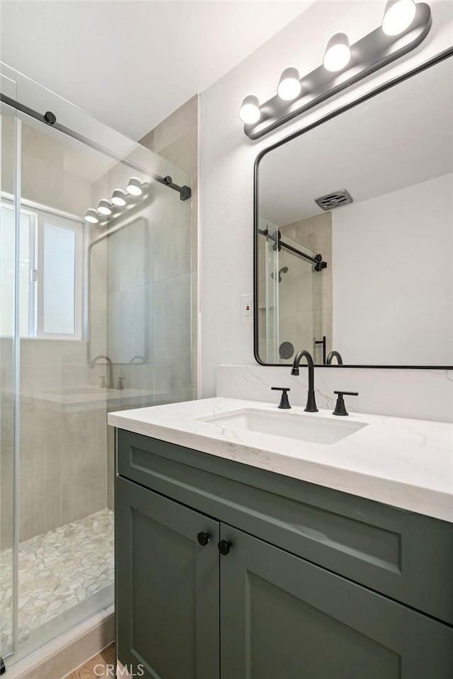 bathroom with vanity and walk in shower