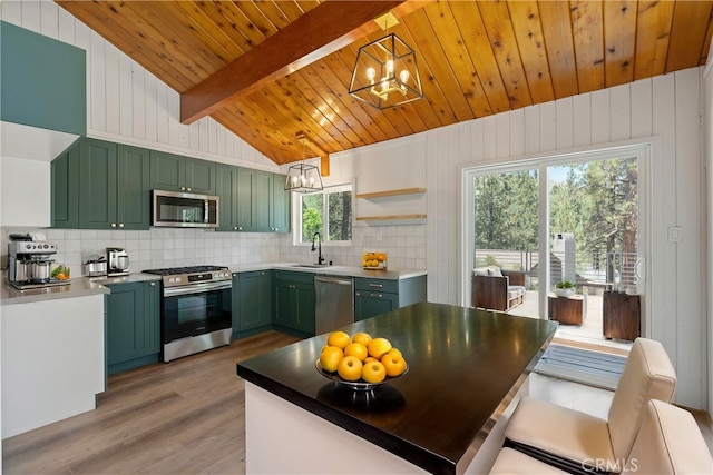 kitchen featuring vaulted ceiling with beams, wood ceiling, decorative light fixtures, green cabinets, and stainless steel appliances