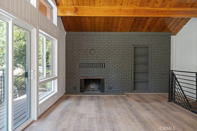 unfurnished living room featuring hardwood / wood-style floors, a fireplace, wooden ceiling, and vaulted ceiling with beams