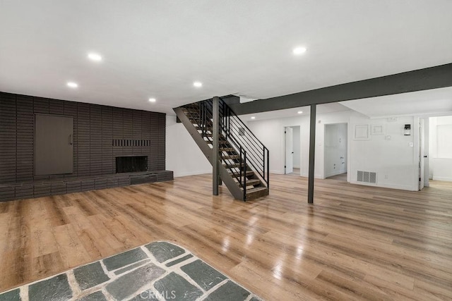 unfurnished living room with a fireplace and light wood-type flooring