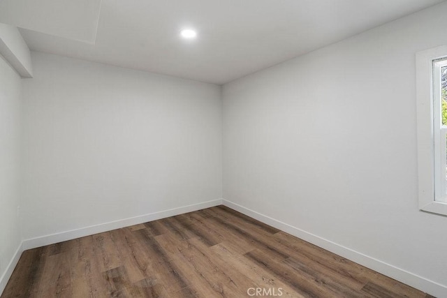 unfurnished room with hardwood / wood-style flooring