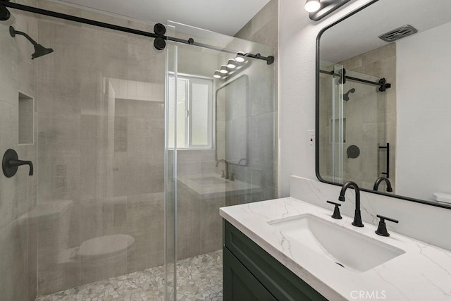 bathroom with vanity and walk in shower