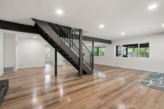 living room featuring plenty of natural light and light hardwood / wood-style floors